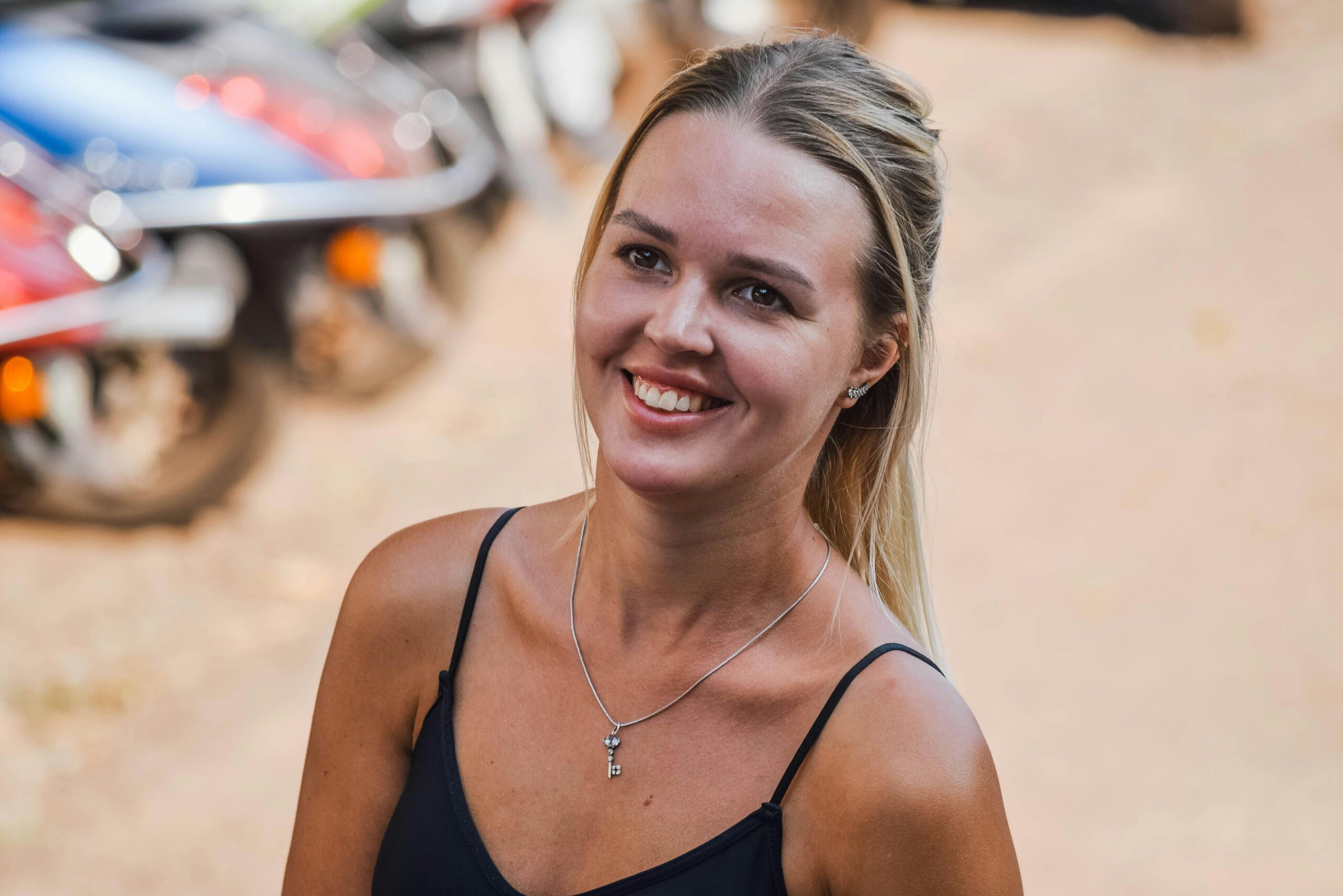 A smiling woman enjoying an outdoor setting in Panaji, Goa, India.